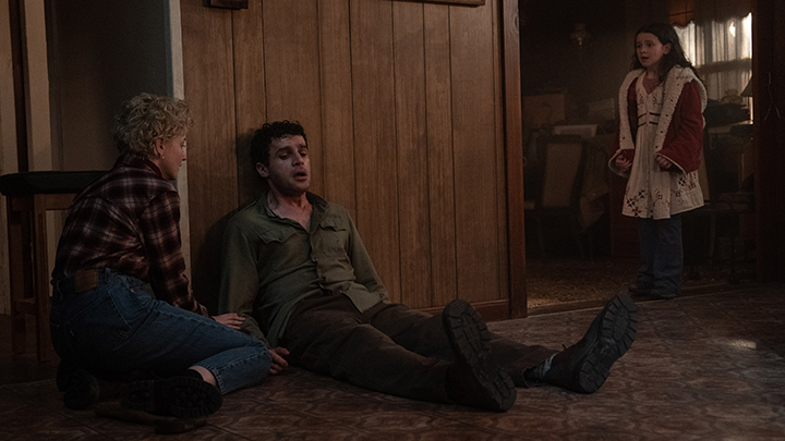 Wolf Man (2025) film still of actors Christopher Abbott, Julia Garner, and Matilda Firth