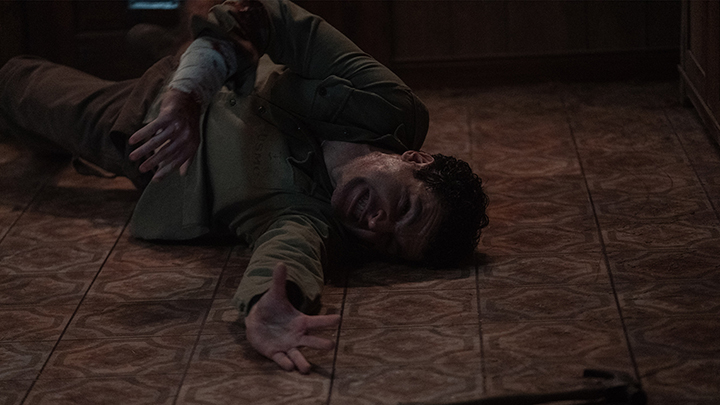Wolf Man (2025) film still of actor Christopher Abbott in pain.